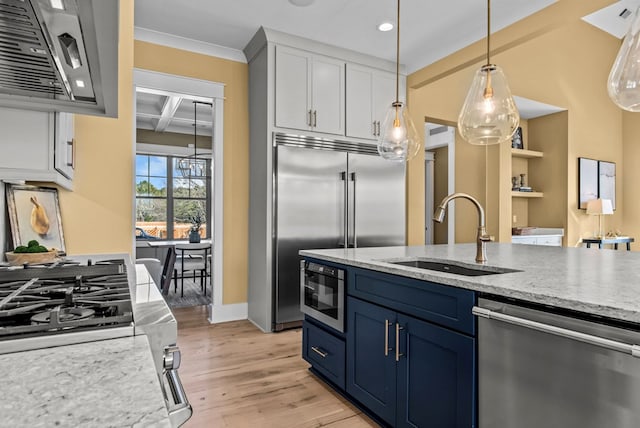 kitchen with blue cabinets, white cabinetry, sink, coffered ceiling, and built in appliances