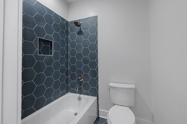 bathroom featuring tile patterned floors, tiled shower / bath combo, and toilet