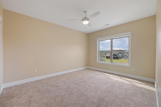 carpeted empty room featuring ceiling fan