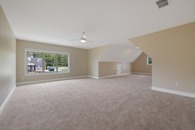 bonus room with ceiling fan, light carpet, and vaulted ceiling