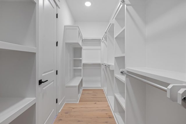 spacious closet featuring light hardwood / wood-style flooring