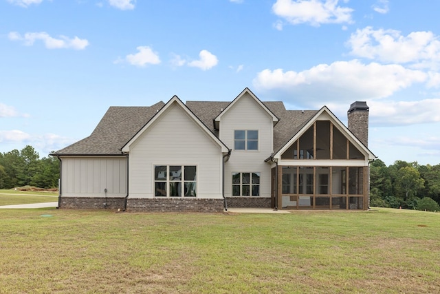 back of house featuring a sunroom and a yard