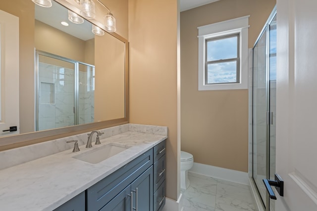 bathroom featuring vanity, toilet, and a shower with door