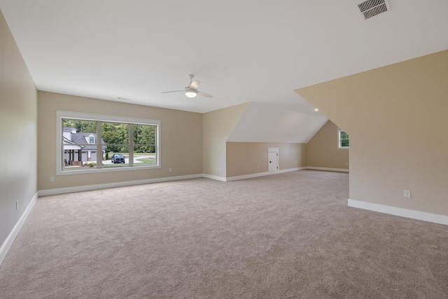 additional living space with lofted ceiling, light carpet, and ceiling fan