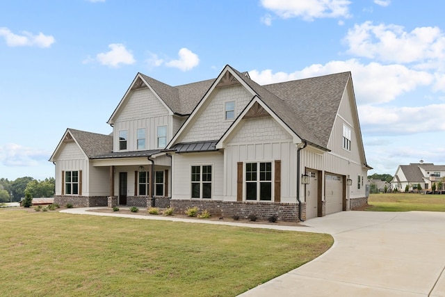 craftsman house featuring a garage and a front yard