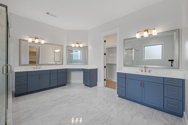 bathroom featuring plenty of natural light, a shower with shower door, and vanity