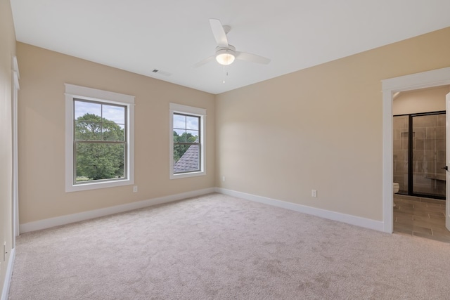 spare room featuring ceiling fan and light colored carpet