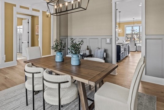 dining space featuring an inviting chandelier and light hardwood / wood-style floors