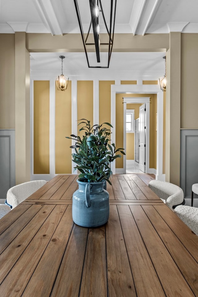 interior space with beamed ceiling and crown molding