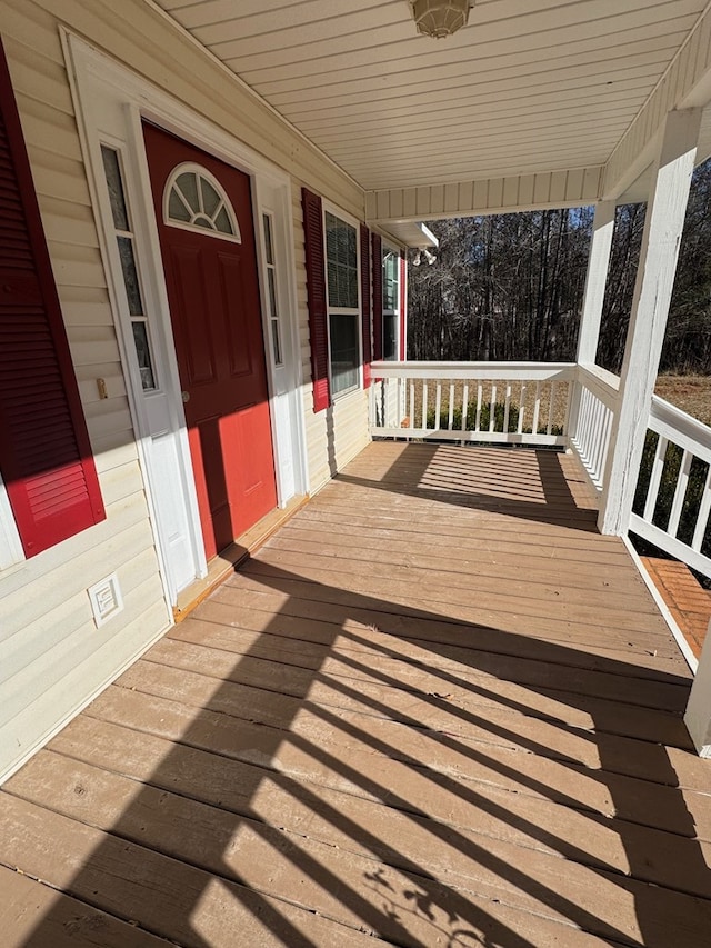 wooden terrace with a porch