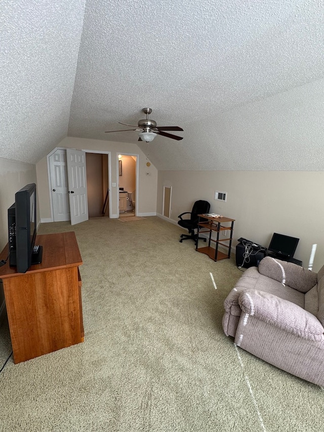 additional living space with ceiling fan, a textured ceiling, carpet flooring, and vaulted ceiling