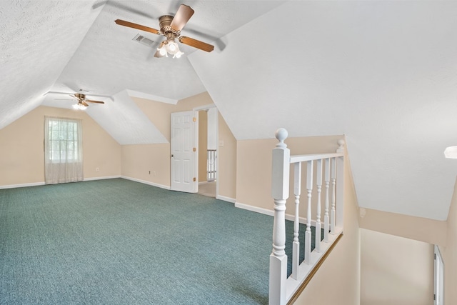 bonus room featuring carpet flooring, ceiling fan, visible vents, baseboards, and vaulted ceiling