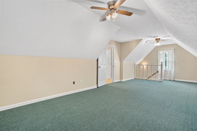 bonus room with baseboards, a ceiling fan, a textured ceiling, and carpet