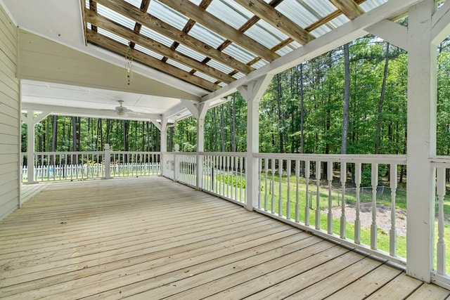 wooden deck featuring a lawn and a ceiling fan