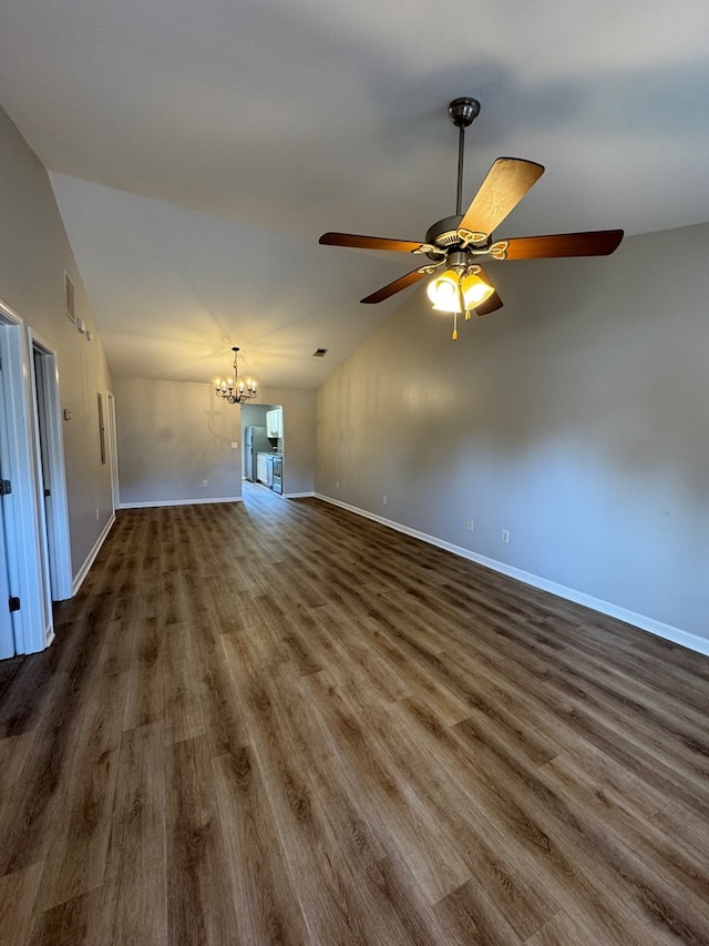 unfurnished living room with dark hardwood / wood-style flooring, lofted ceiling, and ceiling fan with notable chandelier