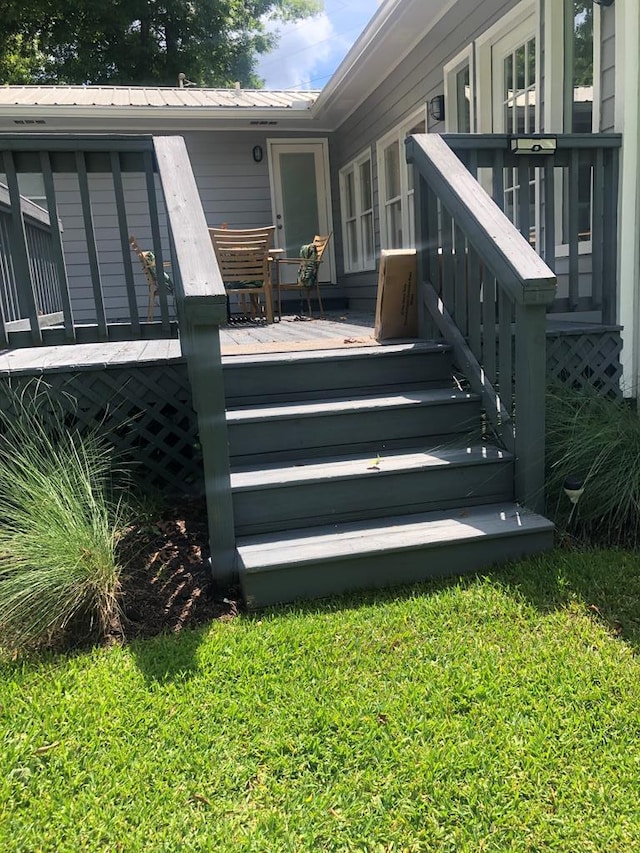 wooden terrace with a yard