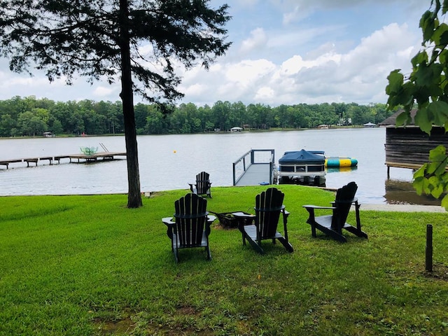 view of yard with a boat dock and a water view