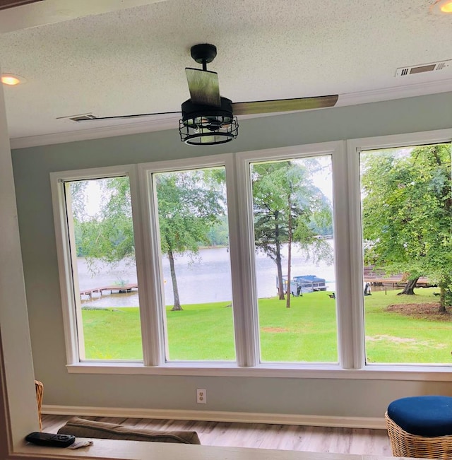 details with crown molding, a water view, a textured ceiling, and an inviting chandelier