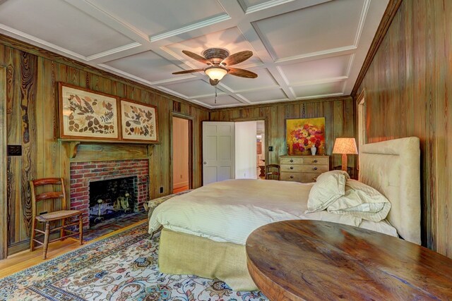 136 Kings Rd, Milledgeville, GA 31061 - bedroom featuring wooden walls, coffered ceiling, wood finished floors, a fireplace, and a ceiling fan