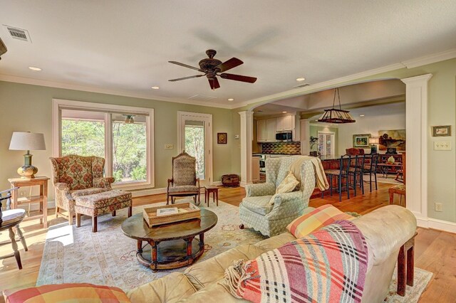 136 Kings Rd, Milledgeville, GA 31061 - living area with decorative columns, light wood-style floors, ceiling fan, recessed lighting, and crown molding