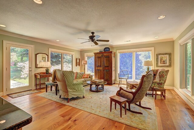 136 Kings Rd, Milledgeville, GA 31061 - living room with crown molding, wood finished floors, a textured ceiling, a ceiling fan, and recessed lighting