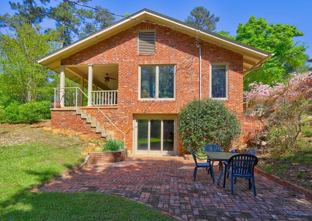 136 Kings Rd, Milledgeville, GA 31061 - rear view of house with stairway, ceiling fan, a patio area, a lawn, and brick siding