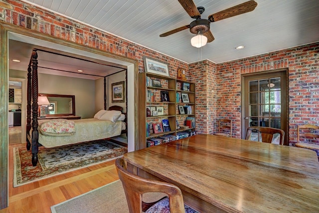 136 Kings Rd, Milledgeville, GA 31061 - bedroom featuring brick wall, wood finished floors, and a ceiling fan