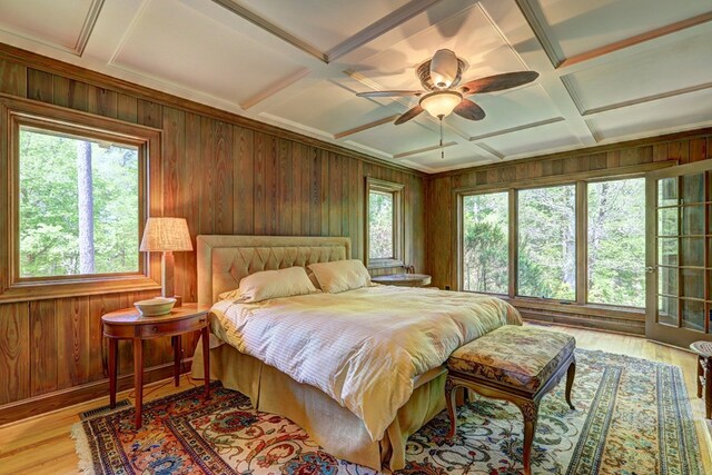 136 Kings Rd, Milledgeville, GA 31061 - bedroom featuring coffered ceiling, wood walls, light wood finished floors, beamed ceiling, and a ceiling fan