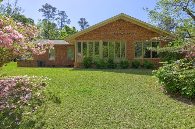 136 Kings Rd, Milledgeville, GA 31061 - back of house with crawl space, brick siding, and a lawn