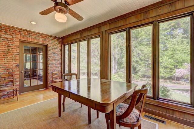 136 Kings Rd, Milledgeville, GA 31061 - sunroom featuring brick wall, wooden walls, and wood finished floors