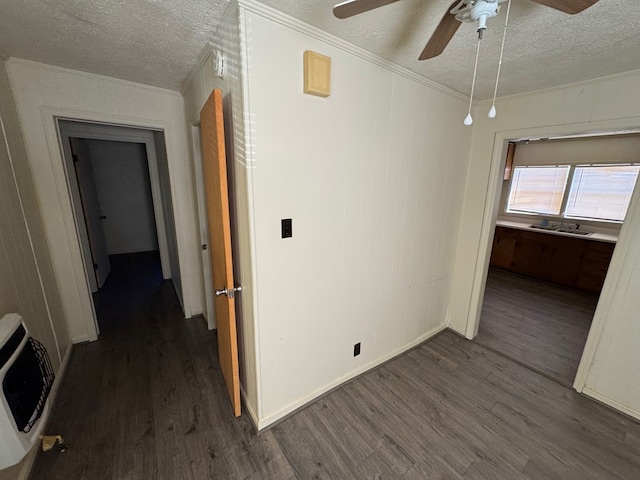 hall featuring crown molding, dark hardwood / wood-style floors, heating unit, and a textured ceiling