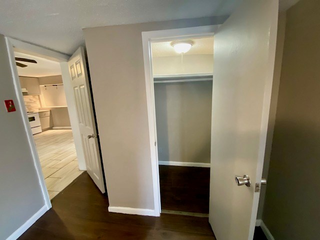 interior space featuring baseboards and wood finished floors