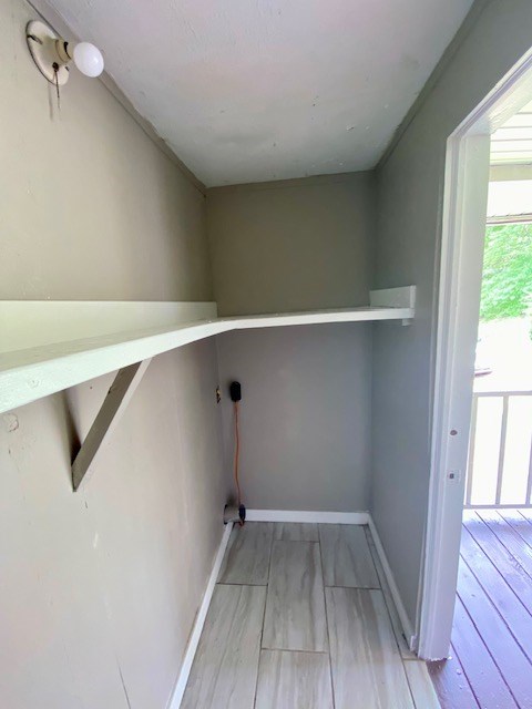 laundry area with baseboards