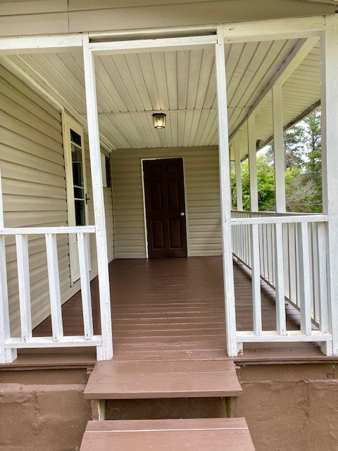 view of exterior entry with a porch