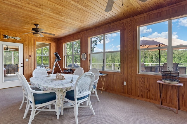 2122 Harbour Point Dr, Sparta, GA 31087 - dining room featuring a ceiling fan, wood walls, wood ceiling, carpet, and baseboards