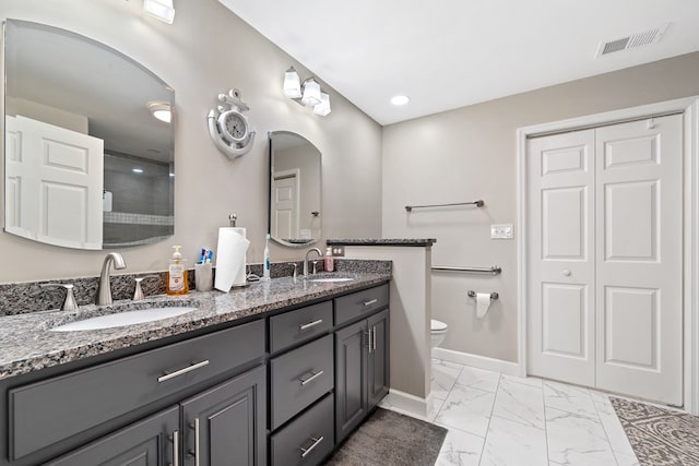 2122 Harbour Point Dr, Sparta, GA 31087 - bathroom with marble look tile flooring, toilet, baseboards, double vanity, and a shower