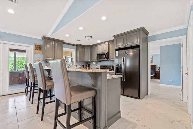 2122 Harbour Point Dr, Sparta, GA 31087 - kitchen with appliances with stainless steel finishes, crown molding, a kitchen breakfast bar, light marble finish floors, and light stone counters