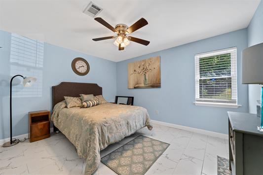2122 Harbour Point Dr, Sparta, GA 31087 - bedroom featuring light marble finish flooring, baseboards, and a ceiling fan