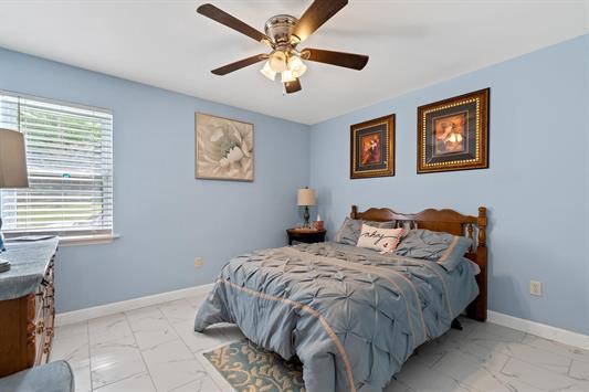 2122 Harbour Point Dr, Sparta, GA 31087 - bedroom with light marble finish flooring, baseboards, and ceiling fan
