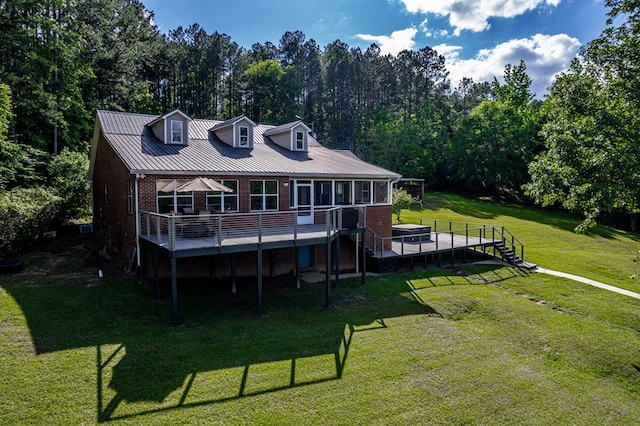 2122 Harbour Point Dr, Sparta, GA 31087 - back of property with brick siding, a deck, stairway, and a yard