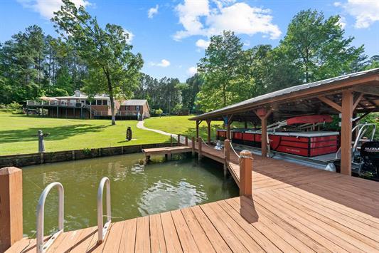 2122 Harbour Point Dr, Sparta, GA 31087 - dock area featuring a water view and a lawn