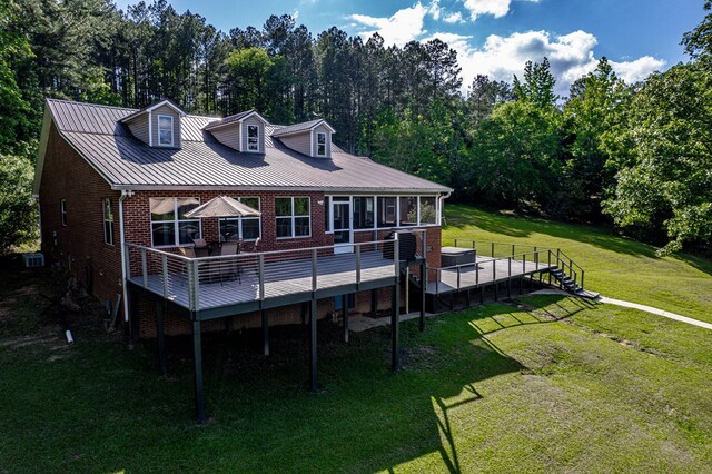 2122 Harbour Point Dr, Sparta, GA 31087 - rear view of property featuring brick siding, a deck, a yard, and a sunroom