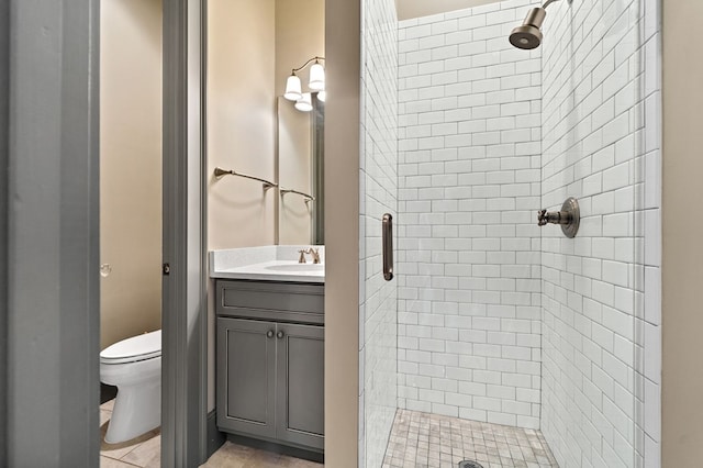 bathroom with a shower with door, vanity, and toilet