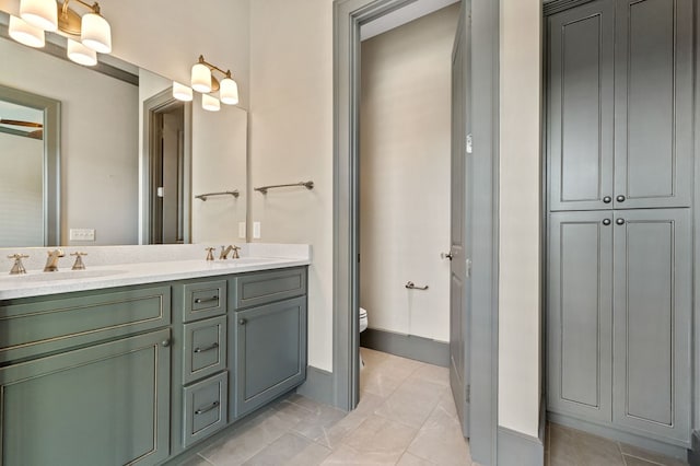 bathroom with vanity, tile patterned floors, and toilet