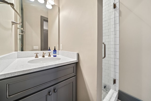 bathroom with vanity and a shower with door