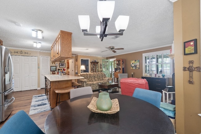 102 E Montego Ct, Milledgeville, GA 31061 - dining room featuring wood finished floors, a textured ceiling, ornamental molding, and a ceiling fan