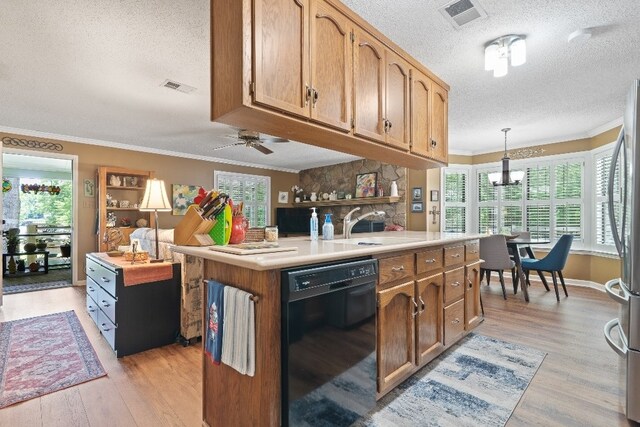 102 E Montego Ct, Milledgeville, GA 31061 - kitchen featuring black dishwasher, a textured ceiling, ornamental molding, healthy amount of natural light, and light wood-type flooring