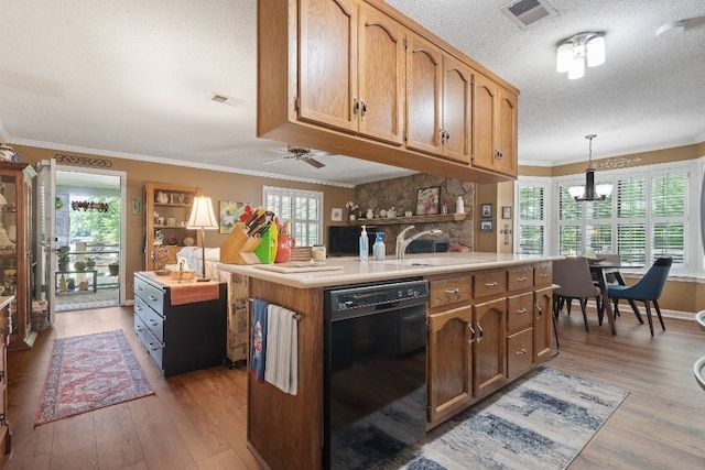 102 E Montego Ct, Milledgeville, GA 31061 - kitchen with black dishwasher, a textured ceiling, light wood finished floors, light countertops, and ornamental molding