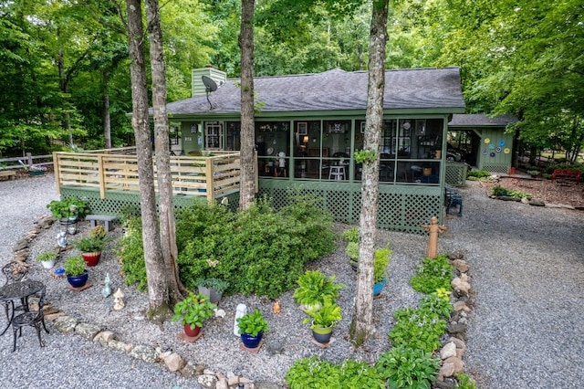 102 E Montego Ct, Milledgeville, GA 31061 - ranch-style home featuring roof with shingles, a sunroom, a chimney, and a deck