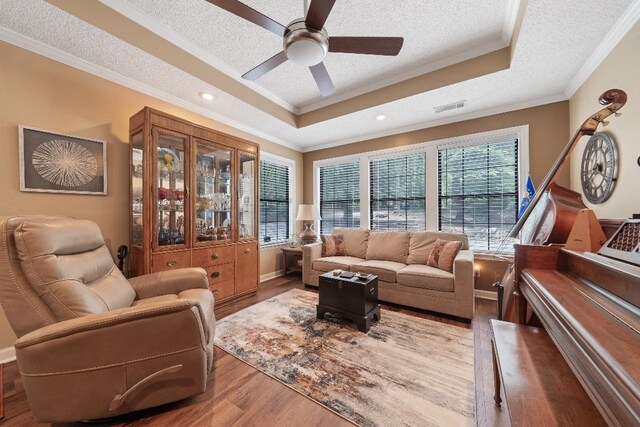102 E Montego Ct, Milledgeville, GA 31061 - living room with a tray ceiling, a textured ceiling, ornamental molding, wood finished floors, and ceiling fan